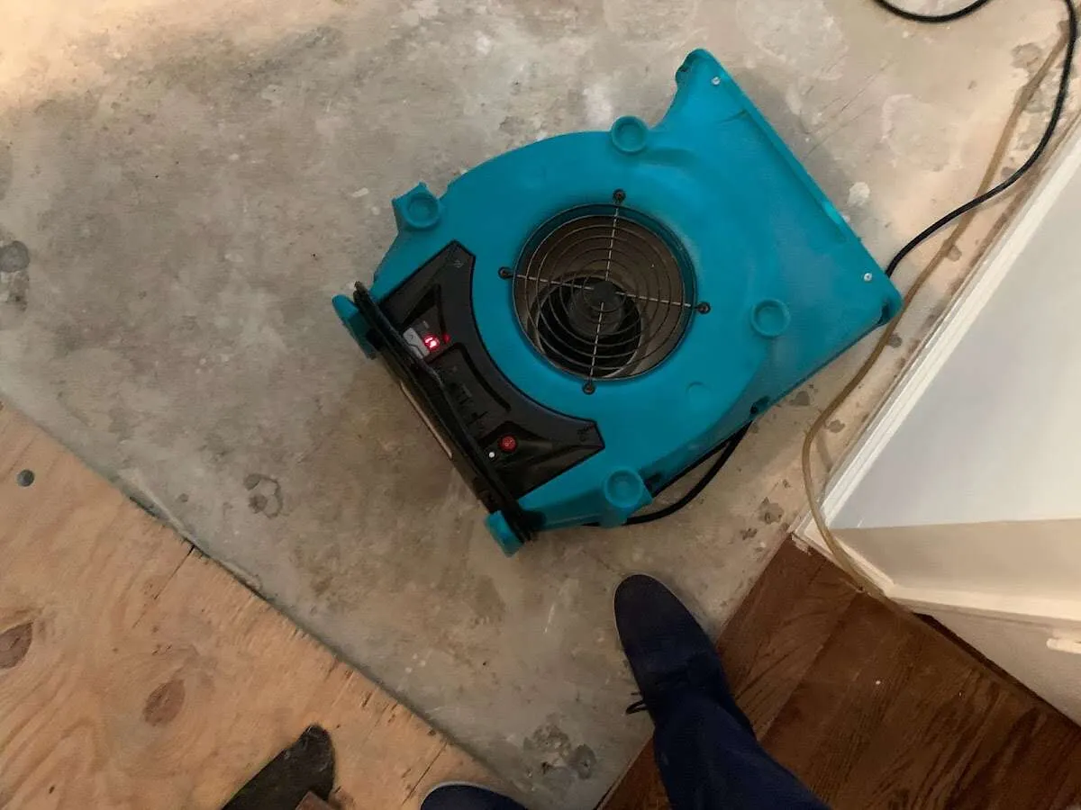 Air mover drying subfloor during Commercial Water Damage Restoration in Matthews
